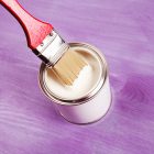 Paint Brush Being Dipped In Can Of White Paint